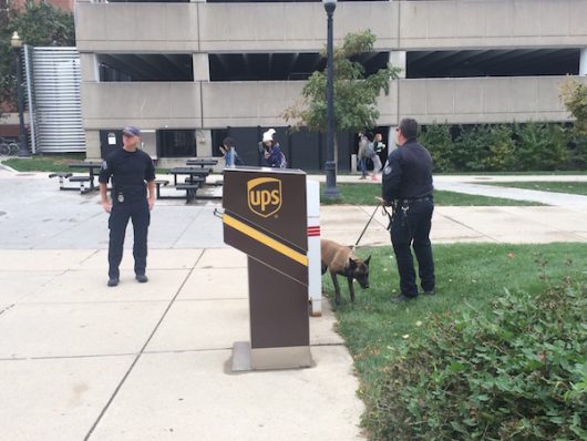 University Police officers and their dog stand outside Bolz Hall. Credit: Nick Roll | Campus Editor