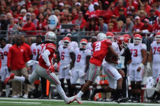 OSU redshirt sophomore cornerback Marshon Lattimore knocks the ball out of the hands of a Rutgers player during the Buckeyes game on Oct. 2. The Buckeyes won 58-0. Credit: Alexa Mavrogianis | Photo Editor