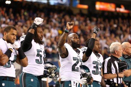Philadelphia Eagles players Steven Means (51), Malcolm Jenkins (27) and Ron Brooks (33) raise their fists in the air during the national anthem for a game against the Chicago Bears on Sept. 19. Credit: Courtesy of TNS