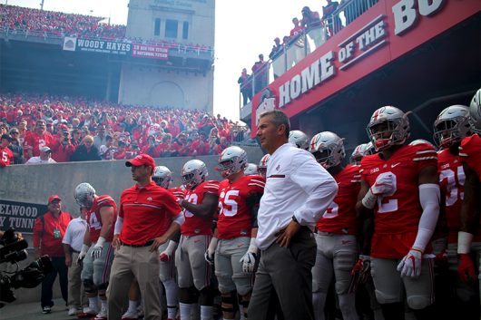 Coach Meyer stands in front of the team before the Buckeyes take the field against Rutgers on Oct. 1. The Buckeyes won 58-0. Credit: Mason Swires | Assistant Photo Editor 