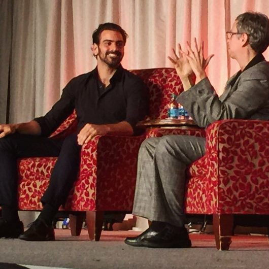 Nyle DiMarco, a deaf male model, addresses a crowd at the Ohio Union on Oct. 17, through an American Sign Language interpreter. Credit: Courtesy of the Ohio Union Activities Board
