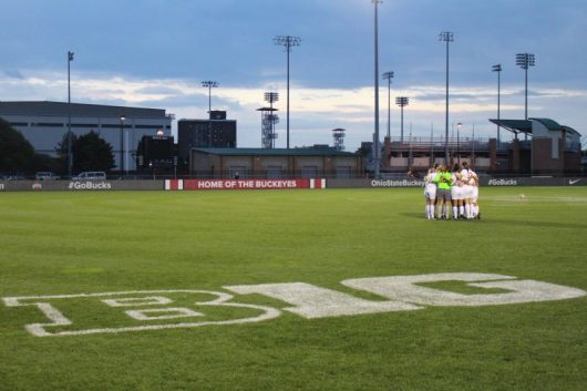 Members of the Ohio State women's soccer team huddles before a game at Jesse Owens Memorial Stadium. Credit: Aaron Tomich | Lantern Reporter