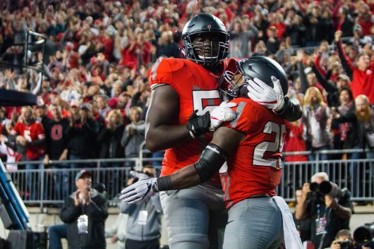 OSU sophomore offensive lineman Isaiah Prince (59) embraces redshirt freshman running back Mike Weber (25) after Weber's touchdown in the first half of the Buckeyes game against Nebraska on Nov. 5. The Buckeyes won 62-3. Credit: Alexa Mavrogianis | Photo Editor