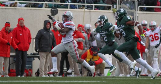 OSU freshman running back Mike Weber (25) outruns two MSU players during their game on Nov. 19, 2016 at Spartan Stadium. The Buckeyes won 17-16. Credit: Mason Swires | Assistant Photo Editor 