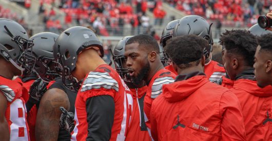 OSU redshirt junior quarterback J.T. Barrett huddles up with teammates prior to the Buckeyes 30-27 double-overtime win against Michigan. Credit: Mason Swires | Assistant Photo Editor