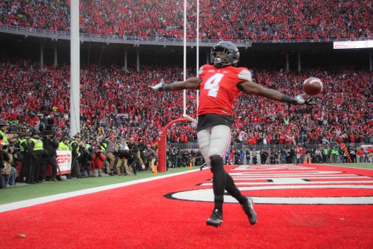 OSU junior H-back Curtis Samuel (4) celebrates as he scores a rushing touchdown in second overtime to win the game for the Buckeyes on Nov. 26 at Ohio Stadium. The Buckeyes won 30-27. Credit: Mason Swires | Assistant Photo Editor