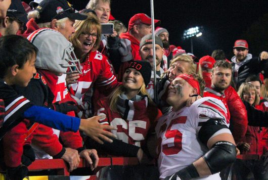 OSU senior offensive lineman Pat Elflein (65) poses for pictures with fans after the Buckeyes 62-3 win against Maryland on Nov. 12.