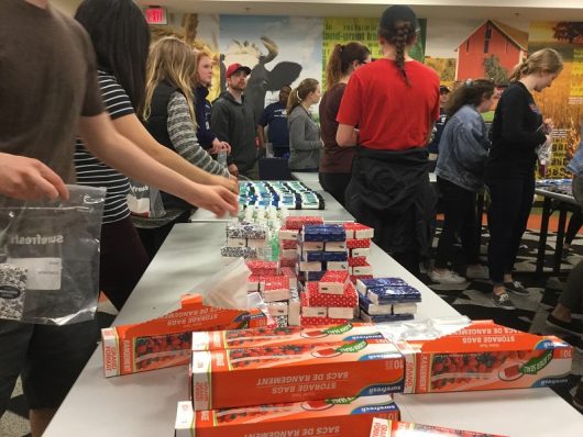 Students move through an assembly line as they prepare care kits for the homeless. Credit: Erin Gottsacker | Lantern reporter